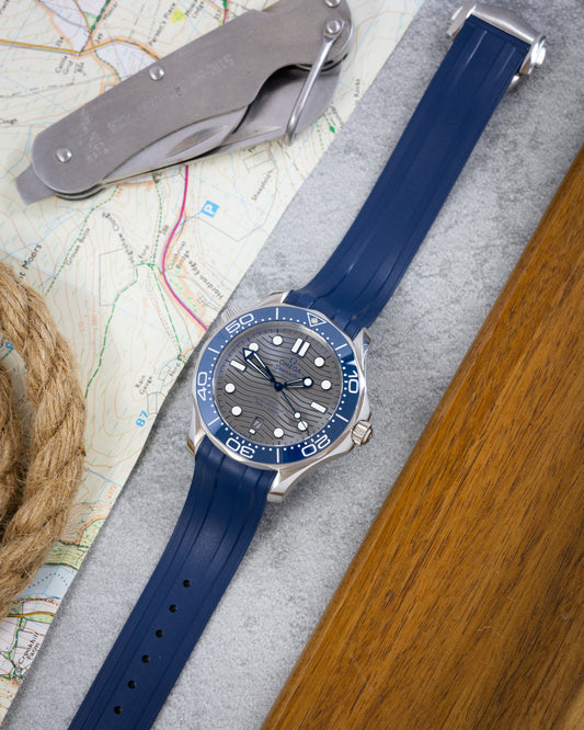 Wristwatch with blue strap on a map background